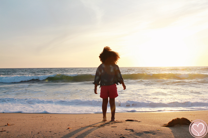 biracial girl at the beach in california