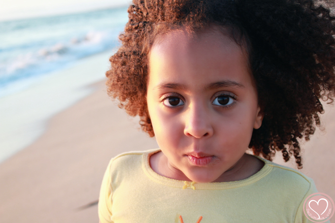 biracial girl at the beach in california