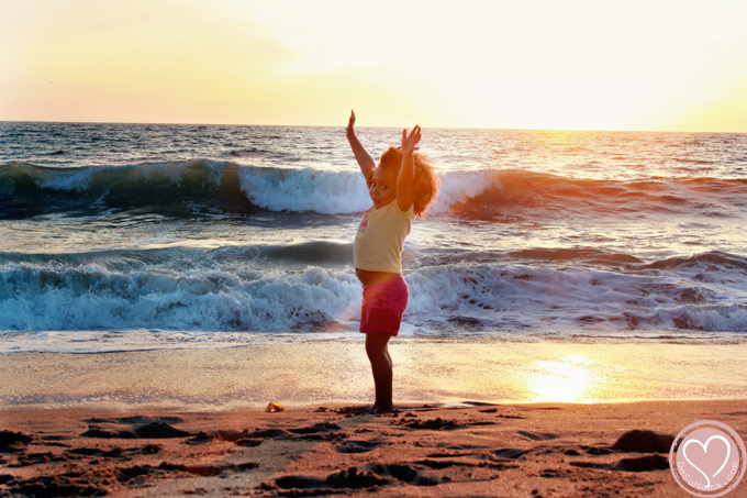 biracial girl at the beach in california