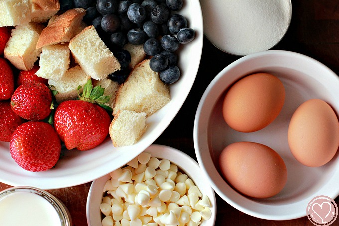 Blueberry Bread Pudding with White Chocolate Chips and Strawberry Sauce, perfect for 4th of July desserts