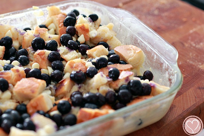 Blueberry Bread Pudding with White Chocolate Chips and Strawberry Sauce, perfect for 4th of July desserts
