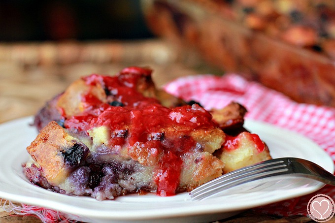 Blueberry Bread Pudding with White Chocolate Chips and Strawberry Sauce, perfect for 4th of July desserts