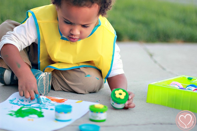 Biracial Boy Learning to Finger Paint