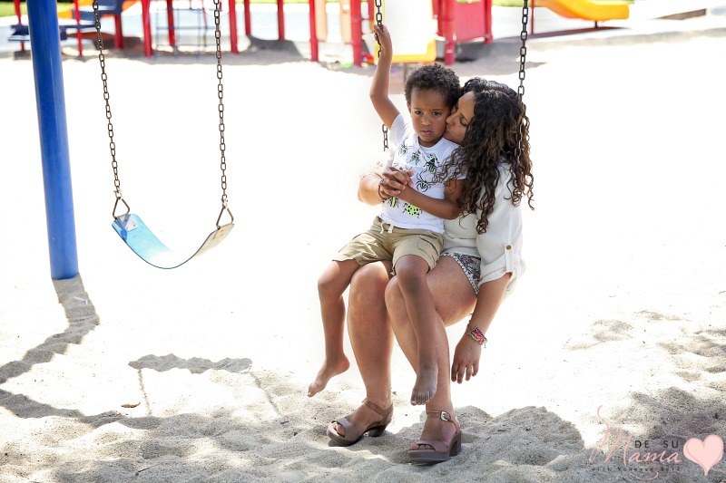 latina mom swinging with black son