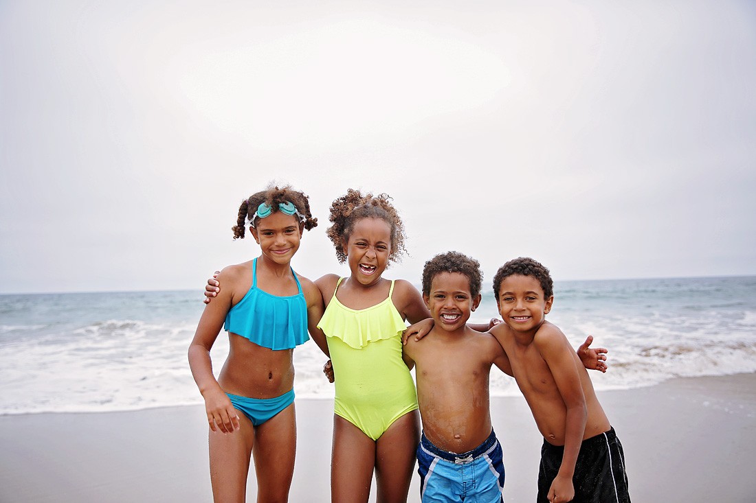 mixed kids on the beach, learning how to make friends