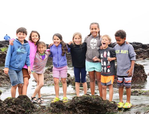 diverse kids camping at the beach